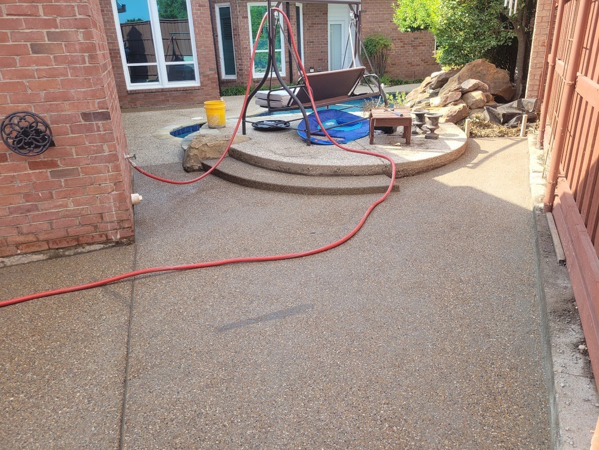 Custom concrete pool in a landscaped Texas backyard