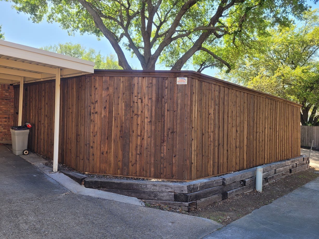 Cedar privacy fence with capped posts along a Dallas backyard