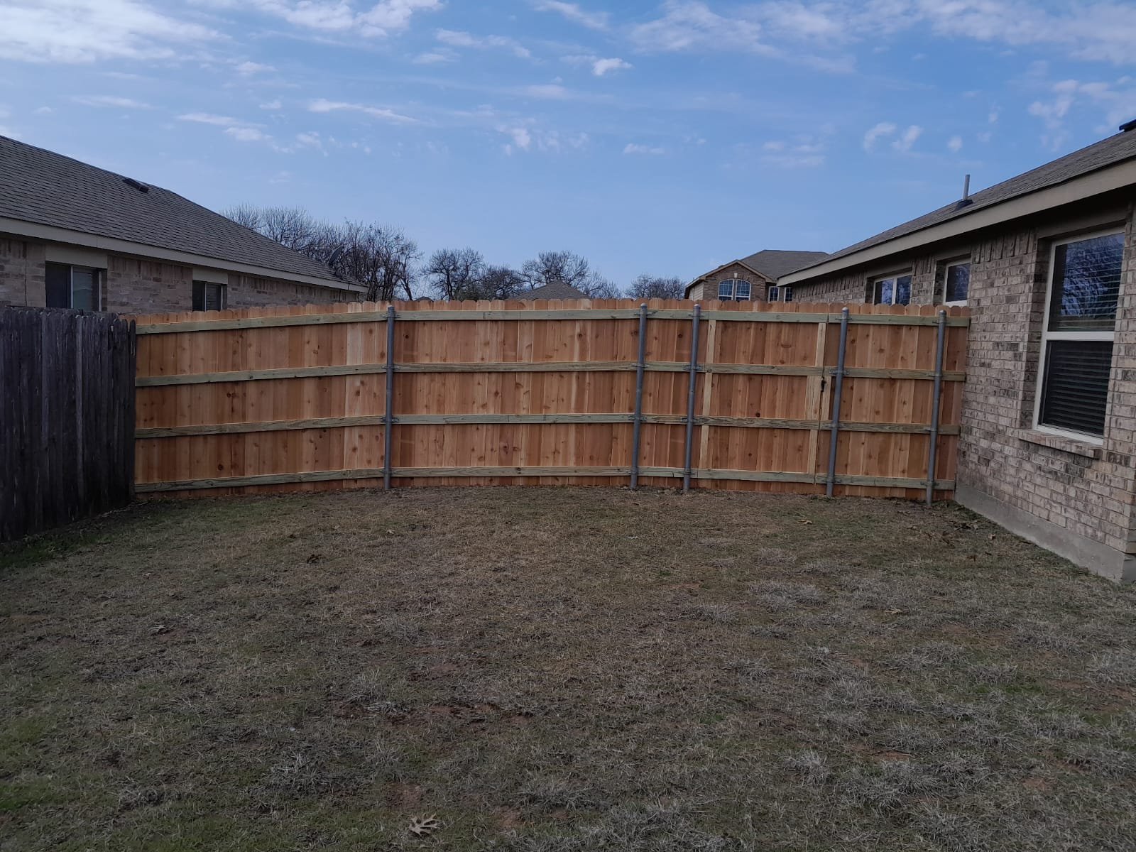 Tall cedar fence enclosing a residential yard