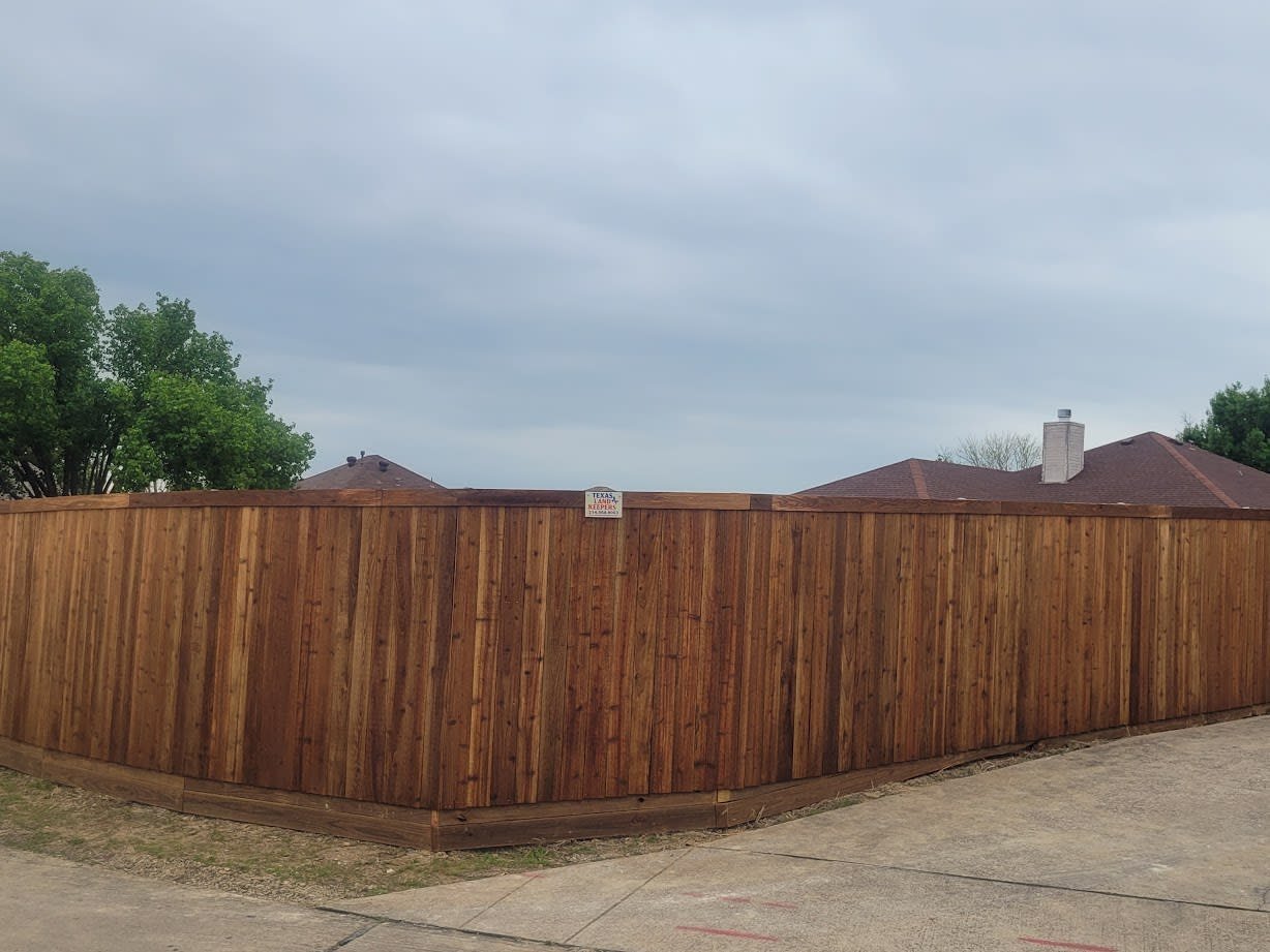 Cedar fence line running along a property boundary