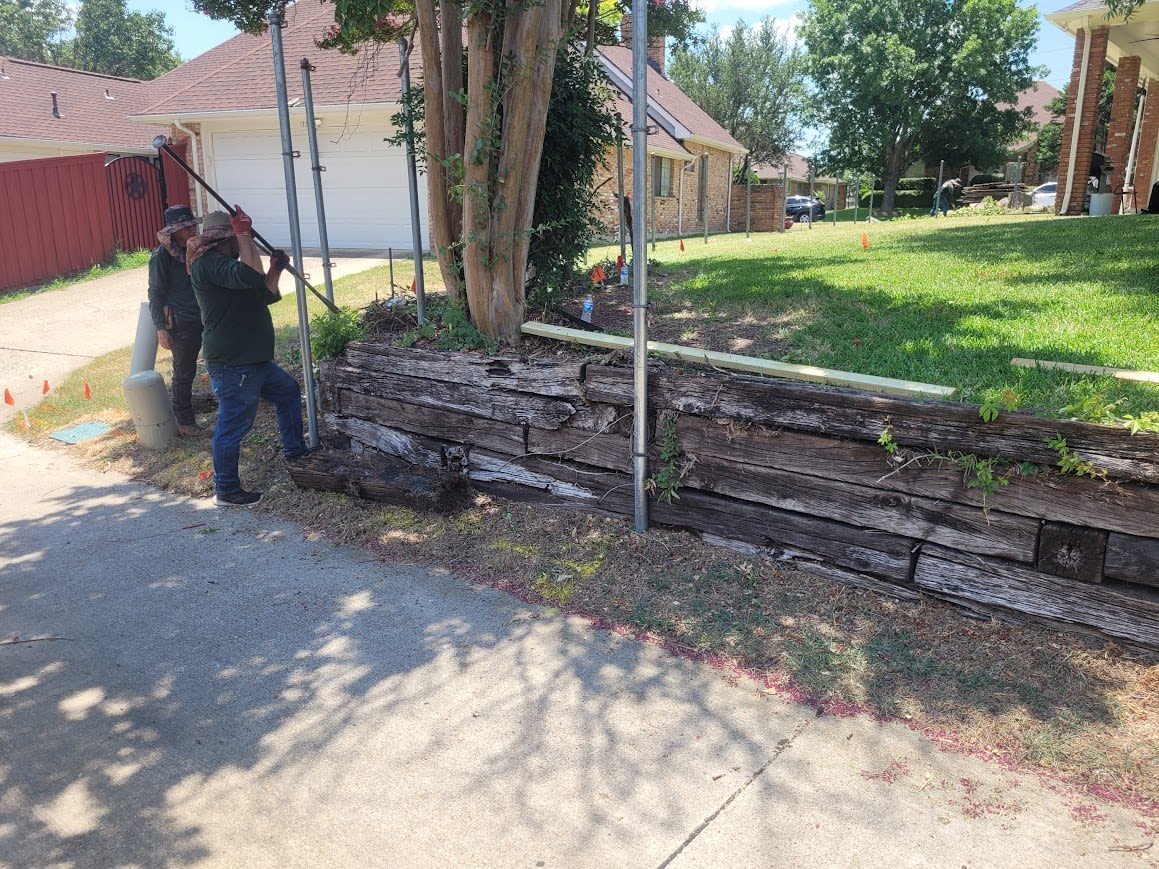 Railroad tie retaining wall holding back a soil embankment