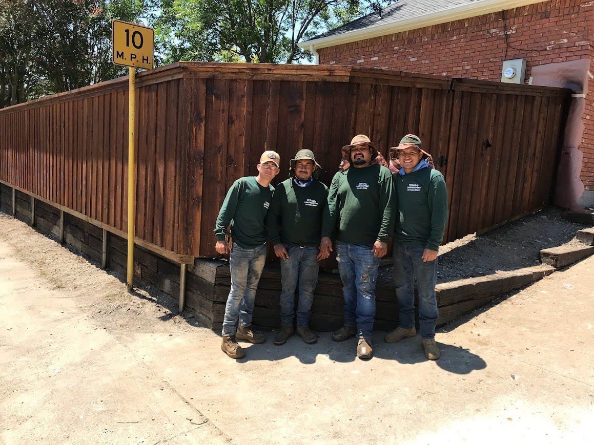 Stacked railroad tie wall edging a raised landscape bed