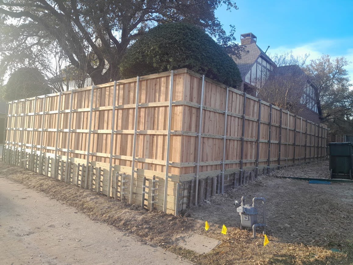 Treated pine retaining wall supporting a landscaped slope